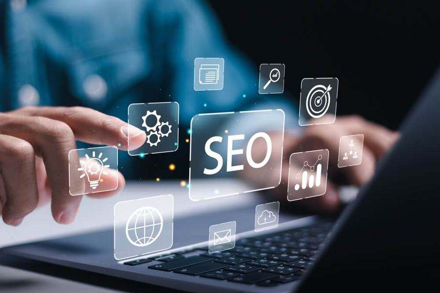 Hand touching a floating SEO interface with search, analytics and target icons above a laptop